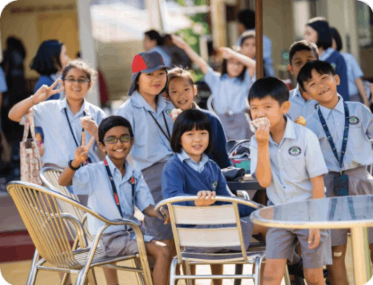 Young students smiling while sitting at a table