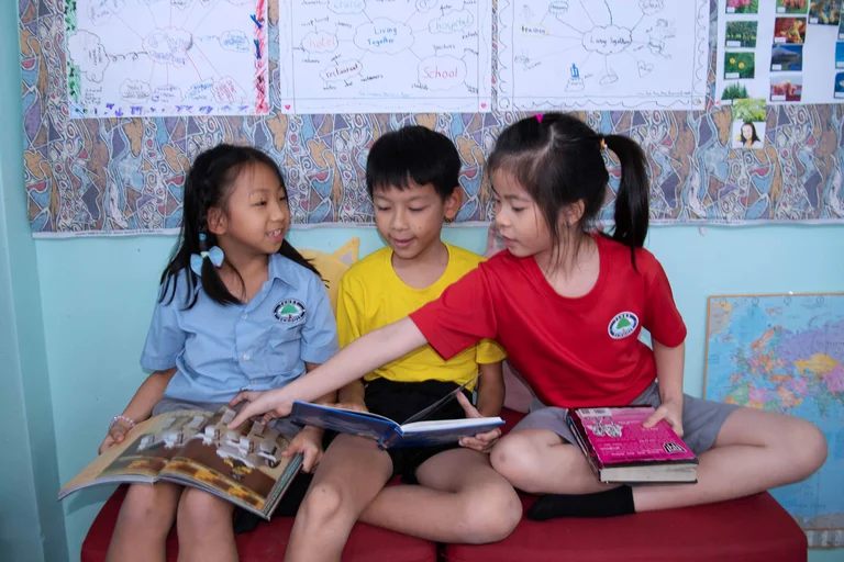 Kids sitting while holding books