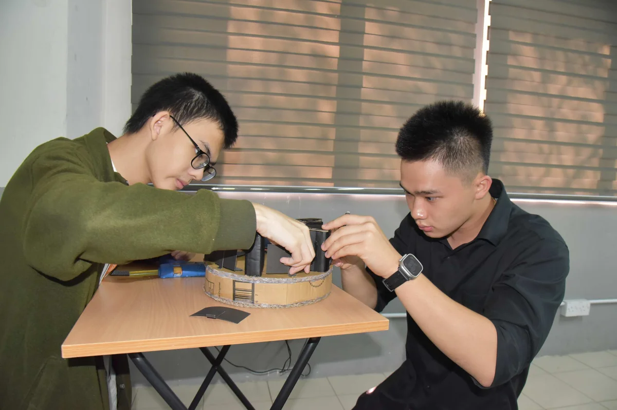 Boys building a DIY device