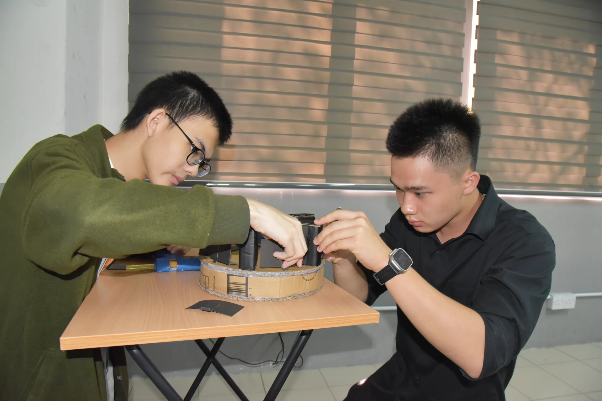 Boys building a DIY device