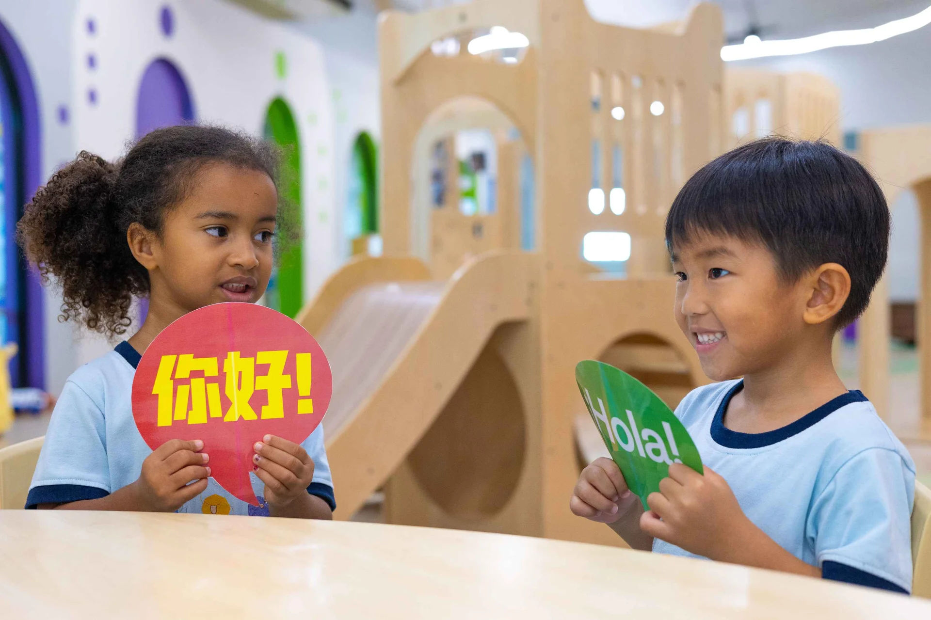 Kids holding greetings signs in different languages