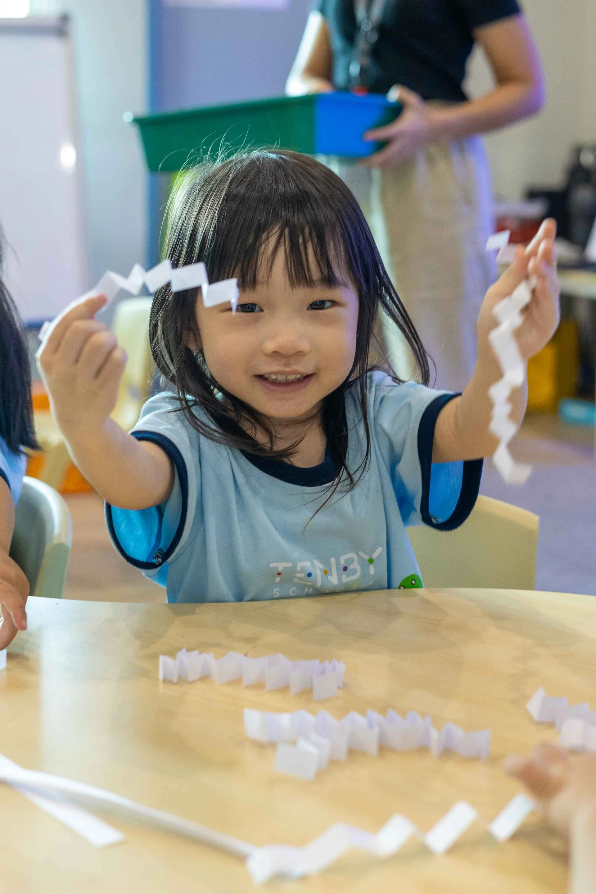 Tenby Schools student playing with paper