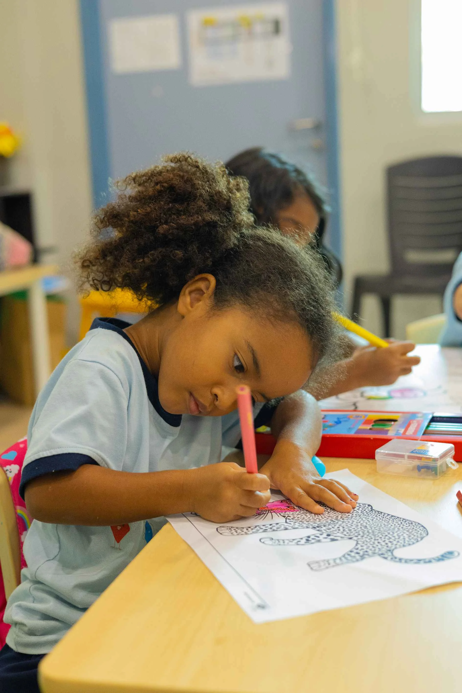 Girl coloring a drawing