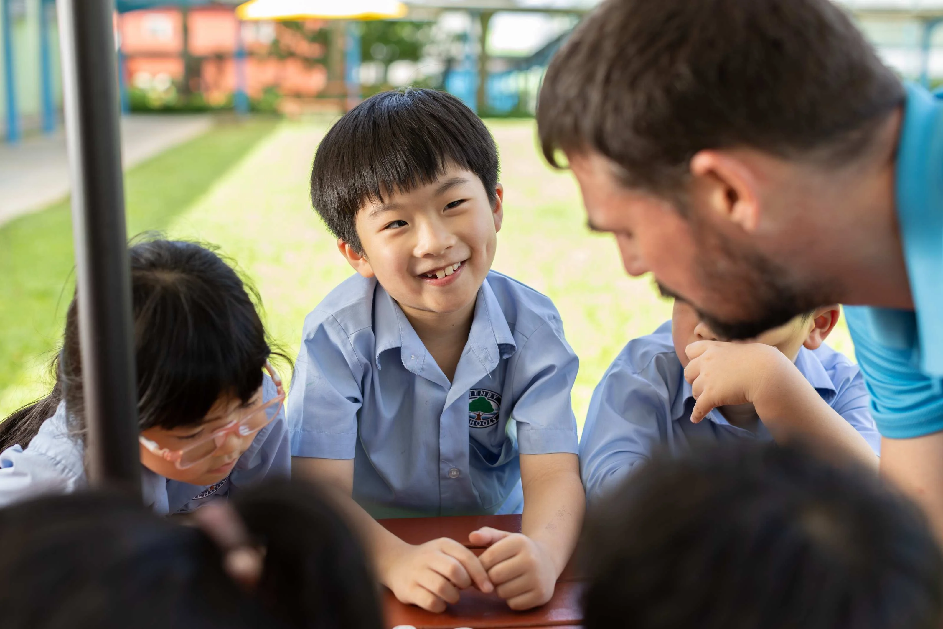 Young student smiling at his teacher