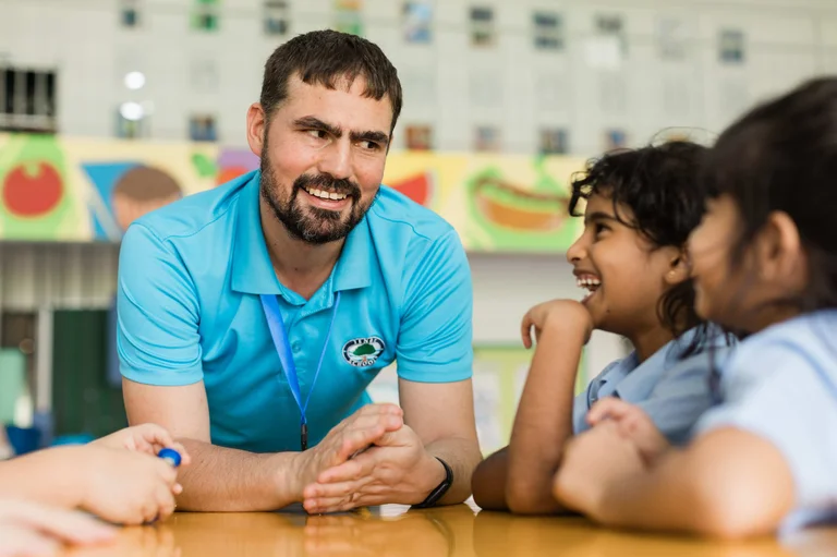 Teacher laughing with his students