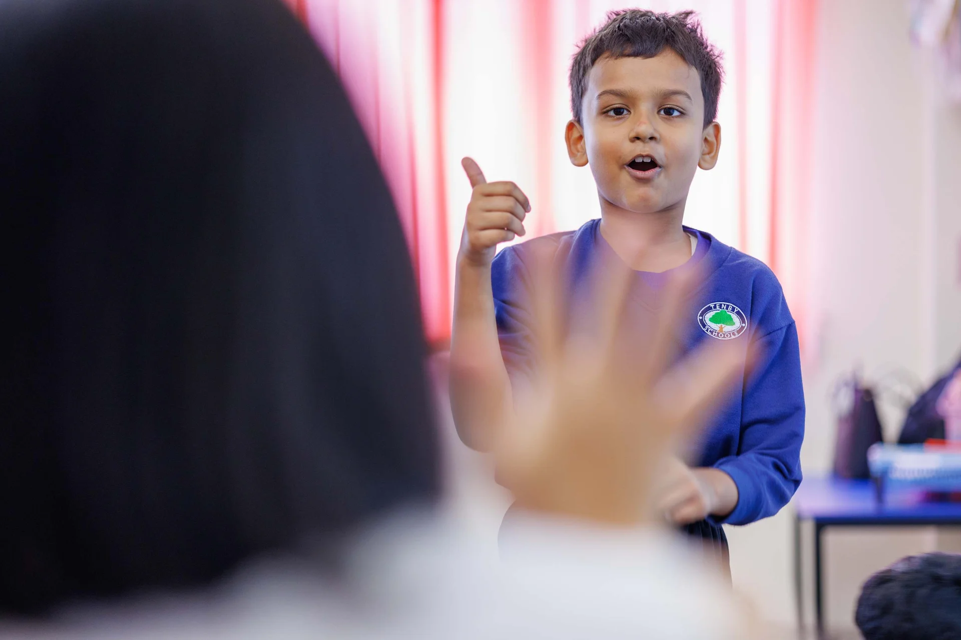 Tenby Schools student counting with his teacher