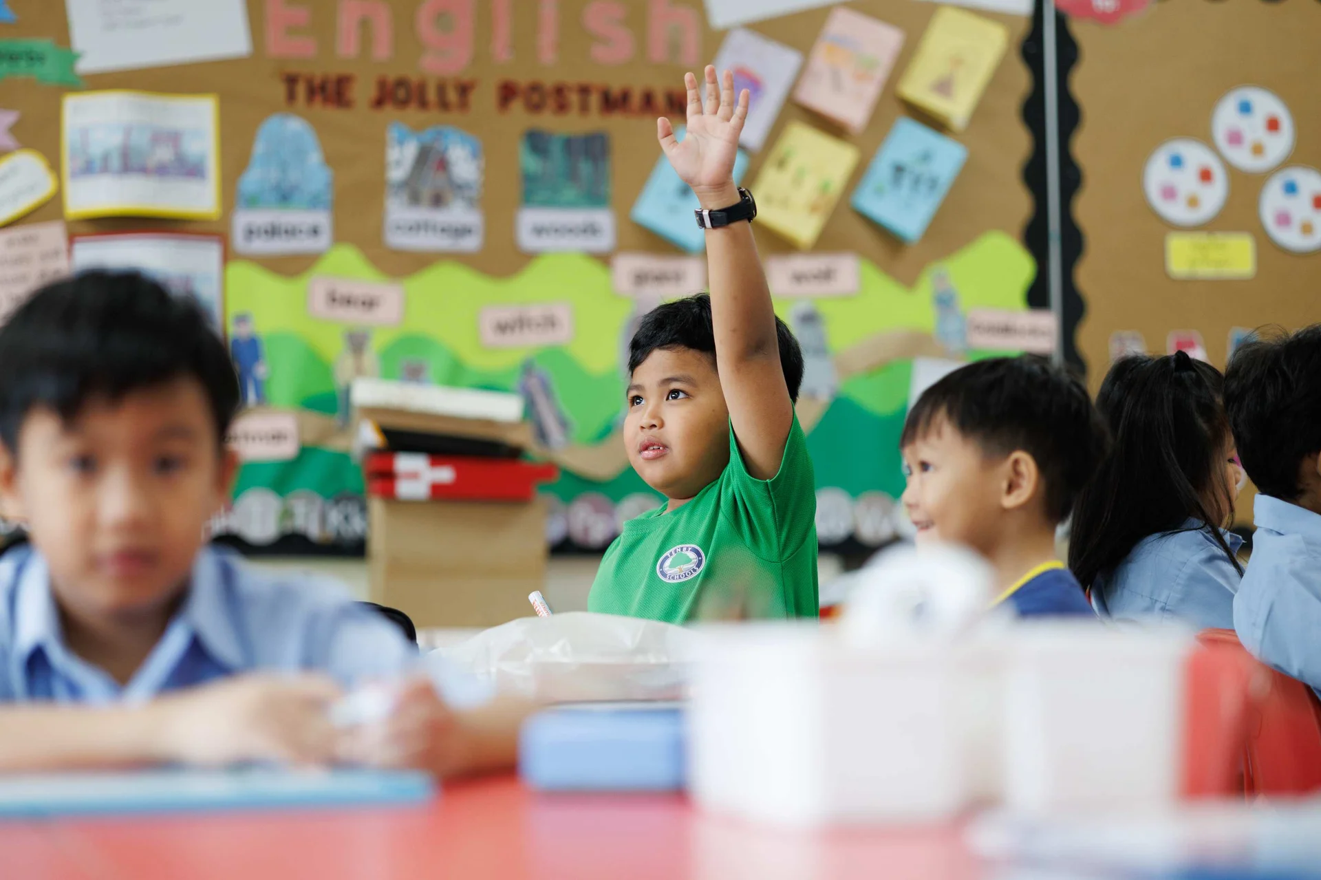Young student raising his hand