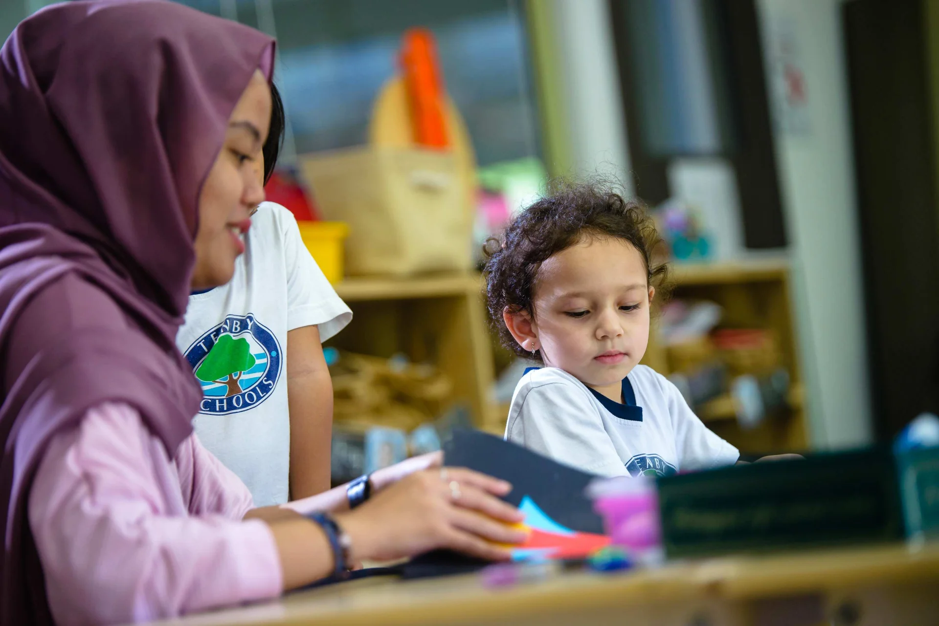 School teacher helping a student